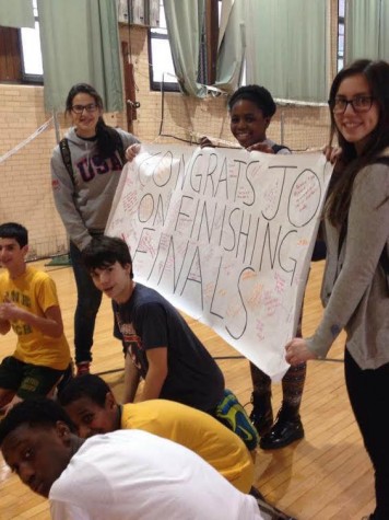 Her friends pose with the poster they made congratulating Bozic for completing this year's first round of finals.