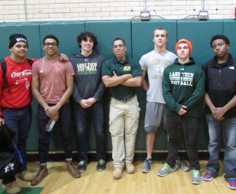 Security guard and coach, Mr. Eddie Lopez, fourth from left, stands with some of his players.