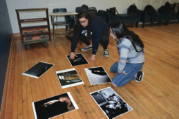 Curators Club members, Elizabeth Valdez, Div. 767, on the left, and Jocelyn Perez, Div. 765, on the right, arranging the photography pieces to be displayed during Lane’s Fall Art Show.