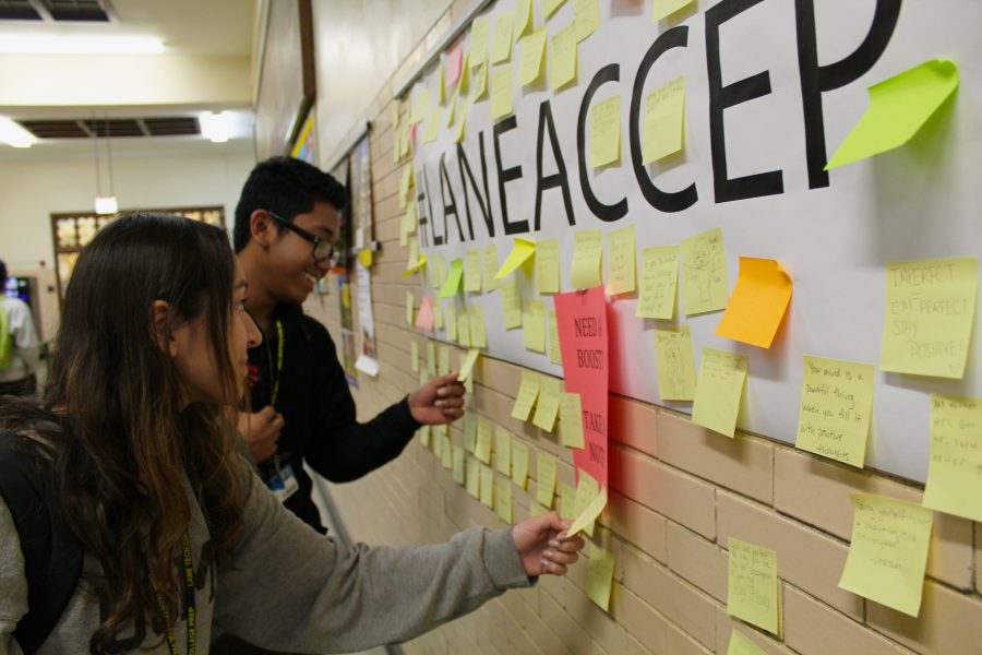 Outside the cafeteria, students stop at the #LANEACCEPTS sign and pick up a post-it on their way to class.