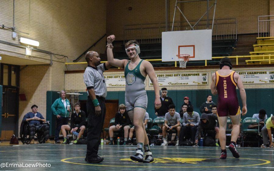 Senior+Will+Downing+smiles+as+he+is+crowned+winner+of+a+match+against+Loyola+in+the+Lane+Wrestling+meet+against+Taft+and+Loyola.+Downing+was+one+of+six+Lane+wrestlers+to+finish+2-0+in+their+matches+as+Lane+rolled+to+a+victory+over+both+schools.+