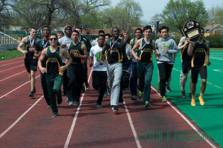 Bennett, middle, leads the track team after their 2013 City Championship.