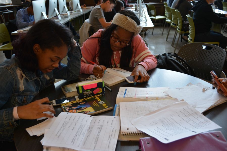 Ronni Brent, Div. 859, left, and Nia Walker, Div. 864, work on homework in the library.