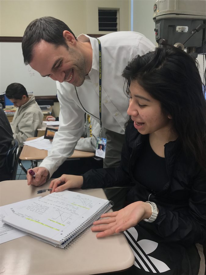 Mr Carity smiles as he helps his student, Priscilla Montalvo, Div. 752, get a better understanding of the material in his AP Macroeconomics class. 