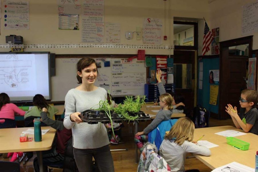 At Hamilton Elementary, 1650 W. Cornelia Ave., Maggie Scholle shows 4th graders various plants from her Aquaponics II class. (Photo courtesy of Katie Gross)
