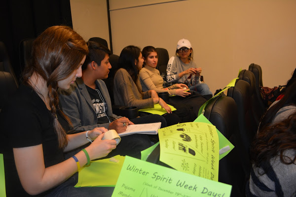 Student Council vice president, Danijela Vranjes, Div. 777, left, and senior council representatives prepare fliers for Winter Spirit Week during a general assembly meeting.