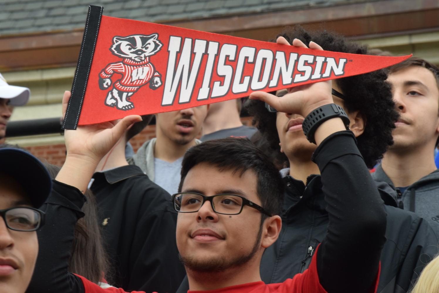 Kevin Vilchez (University of Wisconsin-Madison) poses for class of 2017 picture, proudly holding up a banner from the University of Wisconsin-Madison