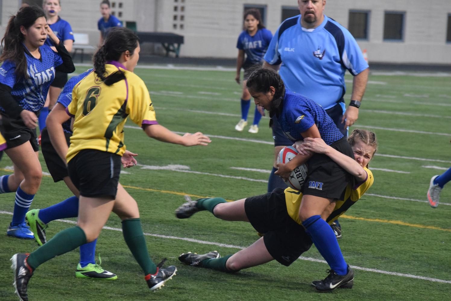 Brianna Galvin successfully tackling Taft player to stop the opposing team in their tracks. 