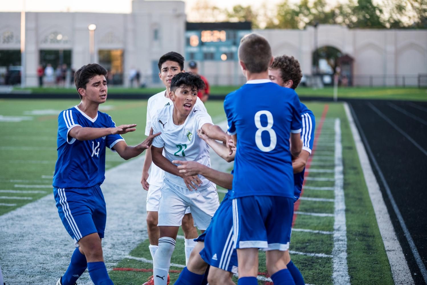 Jose Terrazas, accompanied by some teammates,  takes part in an altercation in an early season game against Taft. The game was called early due to excessive arguing and physicality. (Photo Courtesy of Colin Boyle)