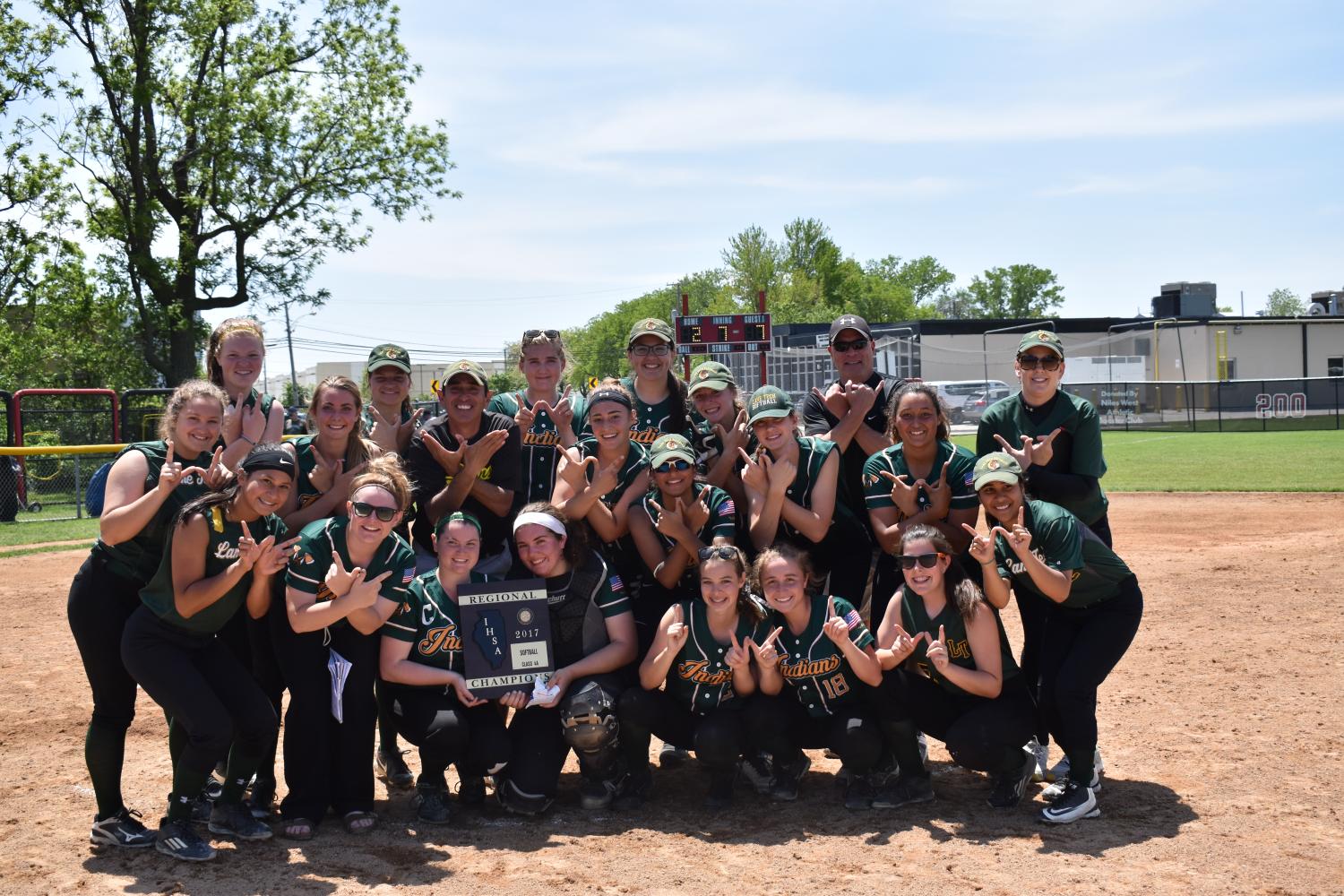 Girls+Varsity+Softball+after+defeating+York+7-2+to+take+home+the+regional+title.+They+followed+the+victory+with+a%0A%0Anarrow+8-7+loss+to+Whitney+Young+but+still+advanced+to+sectionals+for+the+first+time+in+recent+team+history.+%28Greif+Family%29