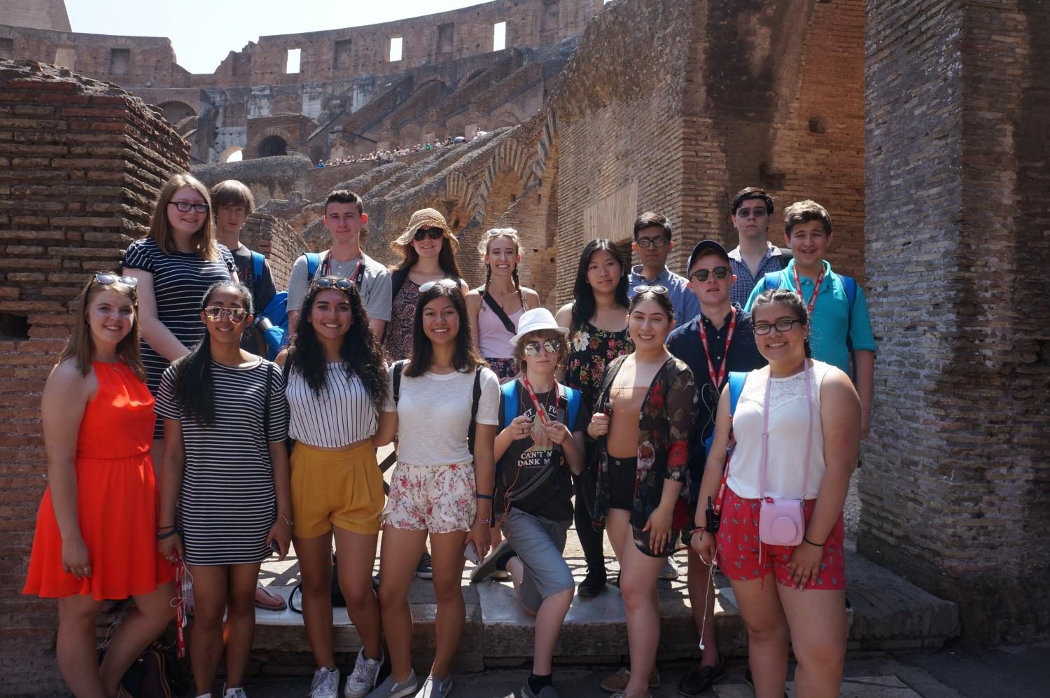 A full group photo of the students at the Colosseum in Rome, Italy.