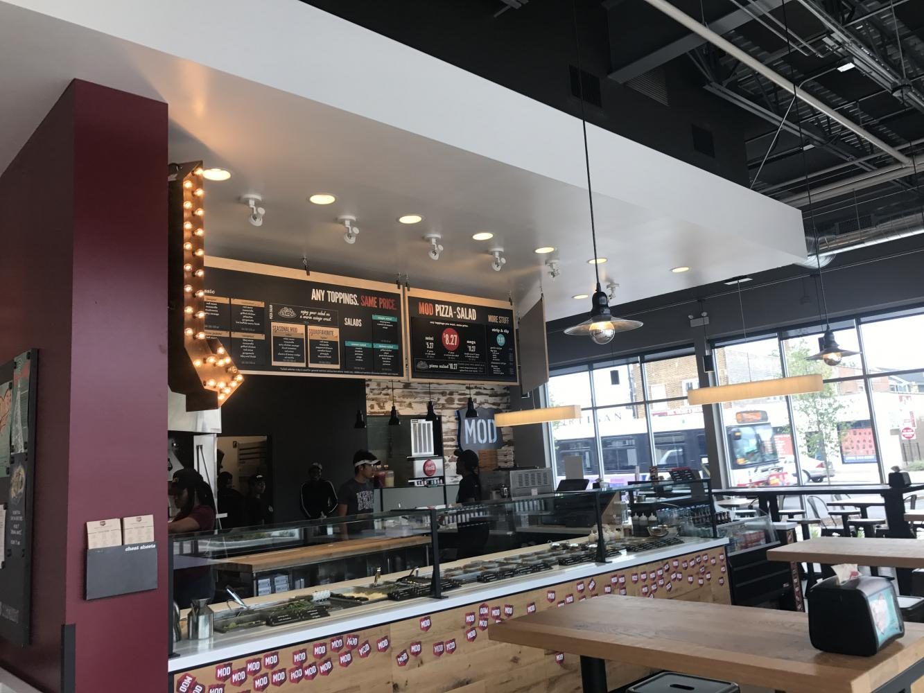 MOD Pizza features menu items that are based off of family friends. Its interior has walls plastered with different artwork. 