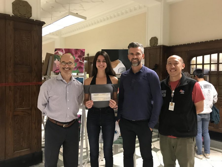 From left to right, Mr. Tennison, Holly Pasquinelli, Div. 860, Mr. Ara, and Mr. Law pose in front of the main office with Pasquinelli’s check. Her award is funded by NCWIT’s partners: Intel, Google, Northrop Grumman and Apple.