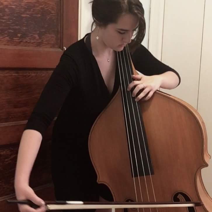 Artist Clara Mikhail playing the bass. Mikhail hopes to continue her music career and play in college. (Photo courtesy of Clara Mikhail) 
