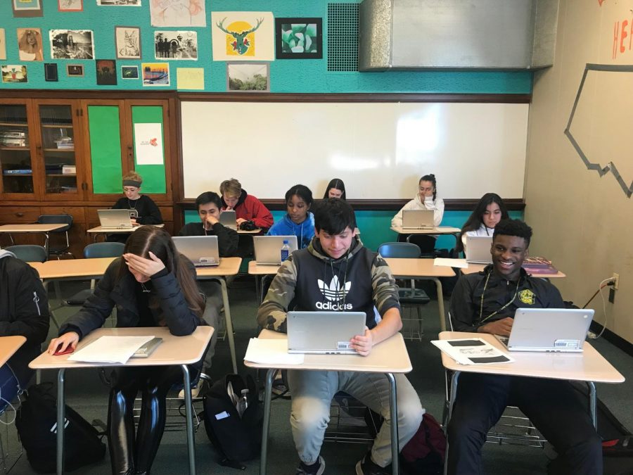 Students doing a class activity on computers in Mr. Doll’s class.