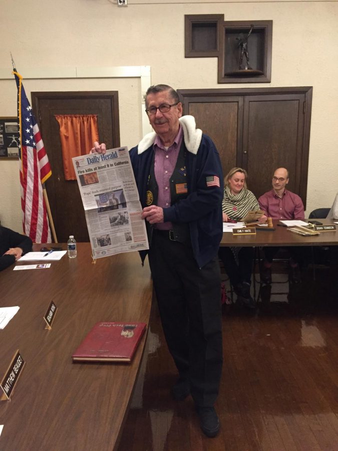 Russell McCann holds the ‘Daily Herald’ article, where he was featured 
for his advocacy on behalf of his fellow veterans.
