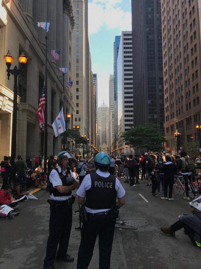 Police officers converse while protesters regroup outside of City Hall after marching from the Harold Washington Cultural Center on 47th Street, June 1, 2020.