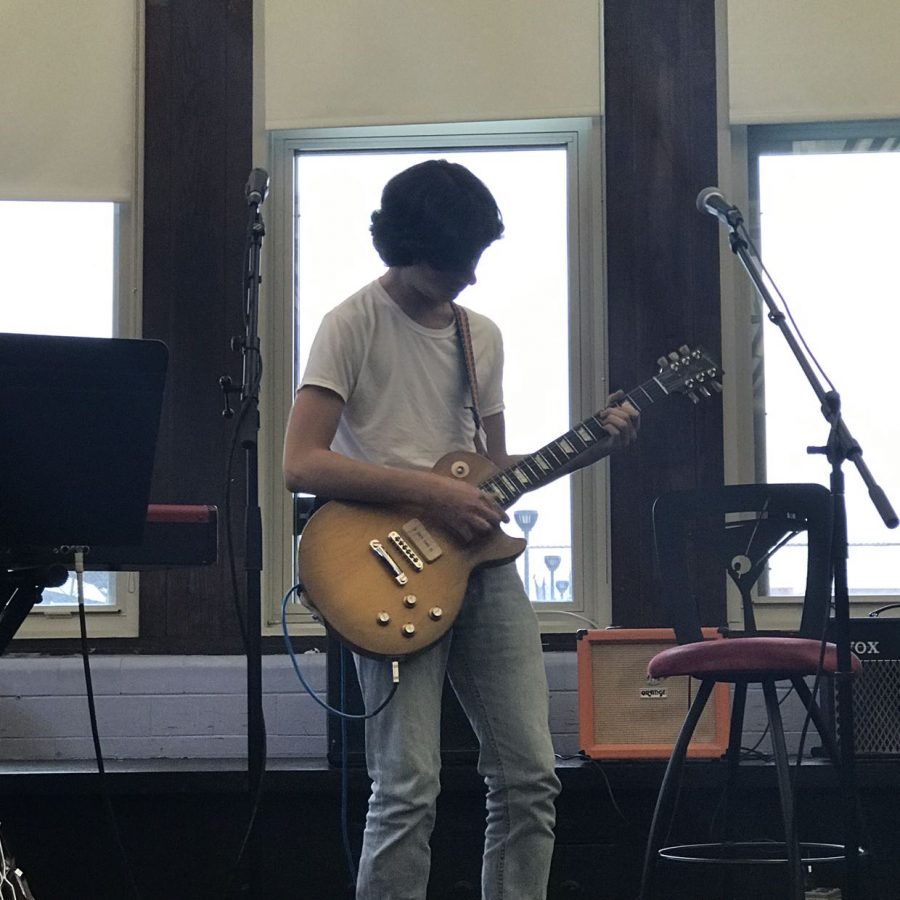 Henry Chmielewski, Div. 165, performs a guitar solo at the Oct. 10 open mic.