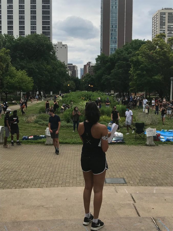 An organizer of the student-led Latin School of Chicago protest against racism speaks to a crowd gathered in Lincoln Park, July 11, 2020.