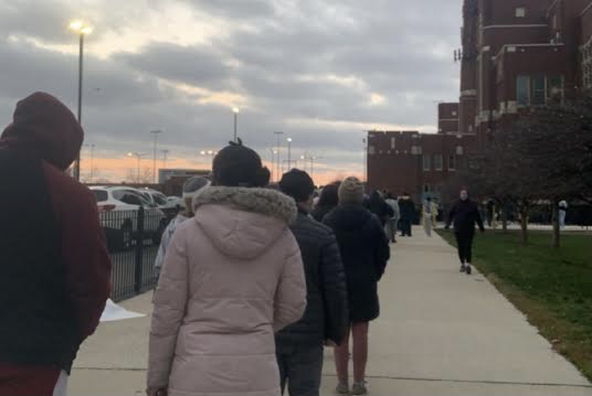 Students must wear masks when waiting in line to take the Selective Enrollment and NWEA MAP tests. Before entering the building, their temperatures and CPS Health Screener results are checked. (Photo Courtesy of Melissa Penafiel)