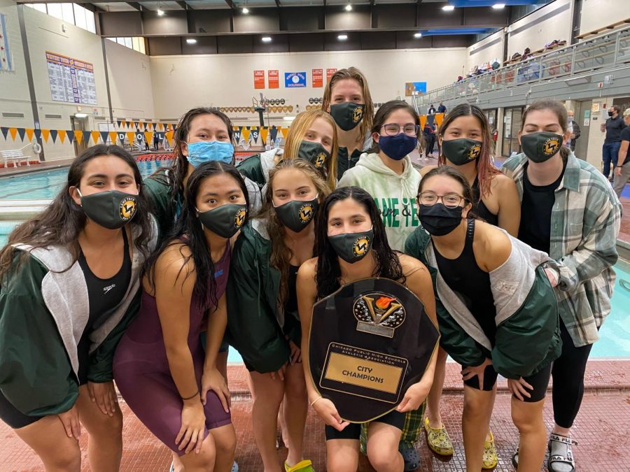 Part of the Lane girls swimming and diving team poses around the city championship plaque after beating Whitney Young to win the team city title. (Photo courtesy of Cece Joshi)
