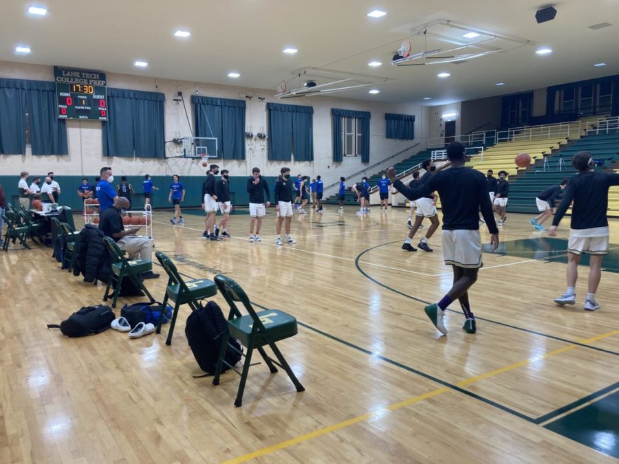 The Lane boys basketball warms up before their game against Taft on March 8. Taft won the rivalry game for the second straight year, beating Lane 56-55.