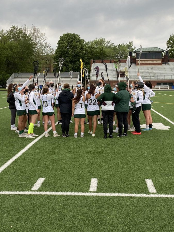 Lane hoists their sticks in celebration of victory.