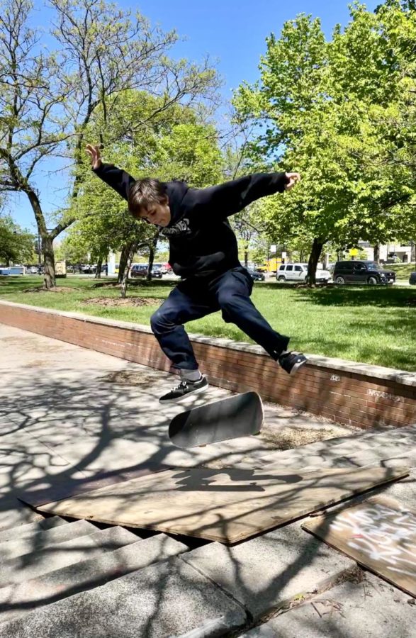 Charlie Hunt pops a textbook kickflip on a ramp made of plywood and other scrap materials brought to Clemente High School.