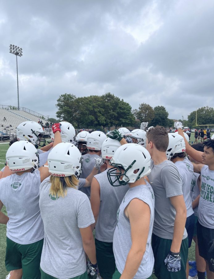 The Lane football team huddles during a summer 7 on 7 tournament at Gately Field in July. (Photo courtesy of  Anna Szwajos)