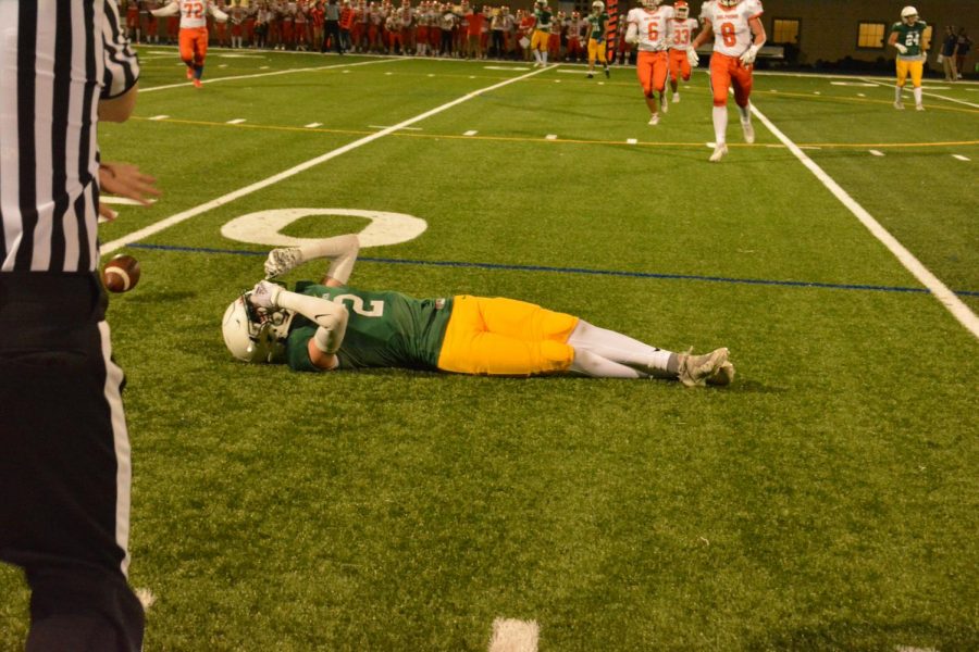 Lane's Payton Gavaldon (#2) lies on the ground after an incomplete pass.