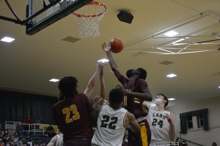 Marshall’s Marcellis Burns (11) jumps above players from both teams for a rebound.

