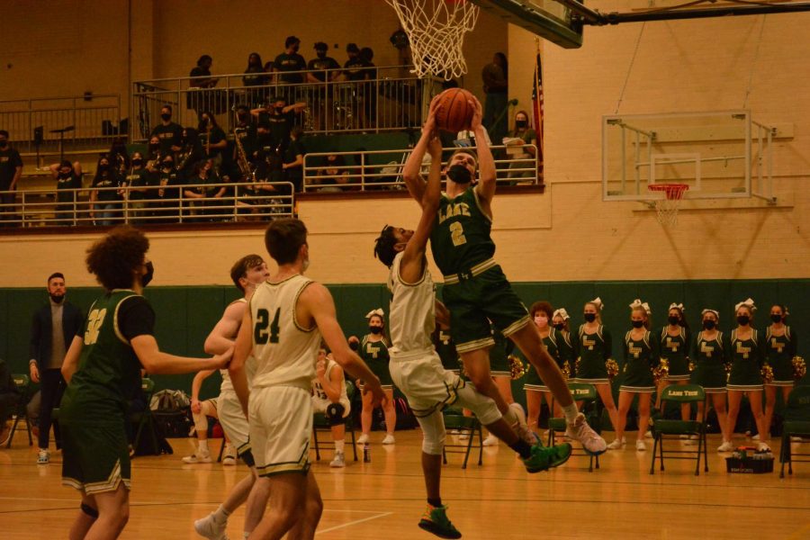 Green’s Jack Tzur (2) attempting a lay-up with White’s Karson Spencer guarding 