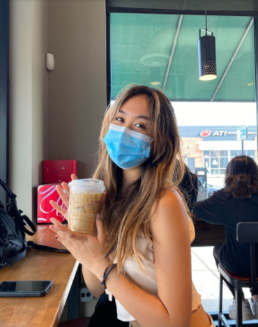 Megan holding up a Starbucks drink