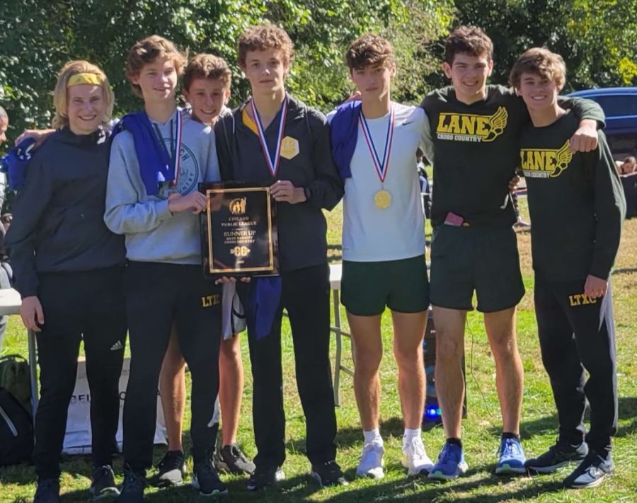 The+boys+varsity+cross+country+team+poses+with+their+runner+up+plaque+after+city+championships.+%28Photo+courtesy+of+Tommy+Stecz%29