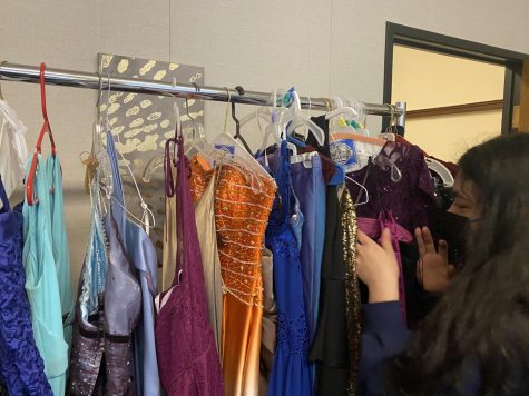 Lane student Aylee Salazar searching for a prom dress in the free pop-up shop on April 22.