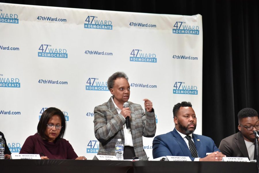 Mayor Lori Lightfoot speaks during the Mayoral Candidate Forum held at Lane on Jan. 15, beside candidates Sophia King, left, and right, Kam Buckner and Ja’mal Green. 