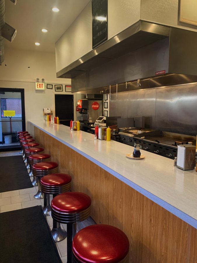 Diner Grill’s row of counter-side seats overlooking the kitchen.