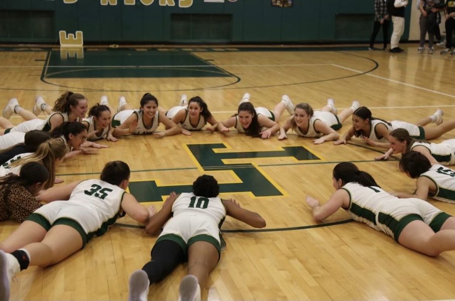 Girls+basketball+does+a+team+cheer+at+midcourt+after+defeating+Amundsen+in+their+Senior+Night+game.+%28Photo+courtesy+of+Delilah+Downes%29
