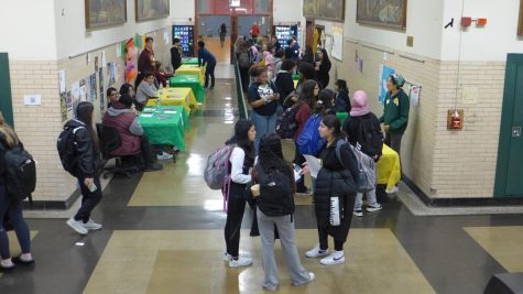 Students gather in the hall near the cafeteria at the Alumni Fair.