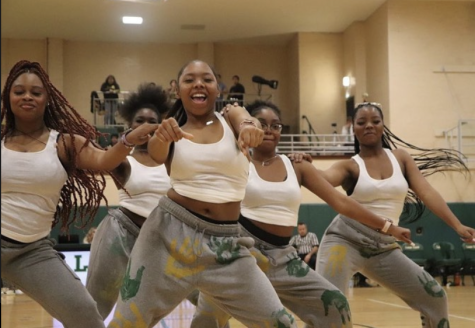 Todays Champerettes perform at halftime of the annual Green and Gold basketball game. Left to right: Malia McDaniel, Mikayla Phillips, Tia Montgomery, Amaya Brown. (Photo courtesy of Christine Lichauco)