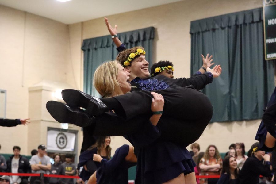 Senior Claire Anderson holds up Senior Kyle Hollman at the end of Ukrainian Club’s routine.