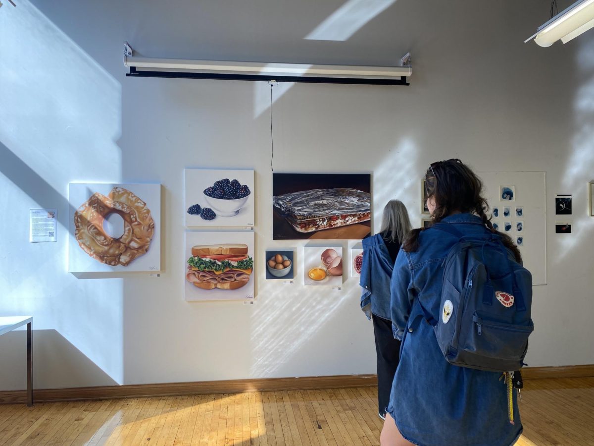 Teachers viewing artwork at the staff art show opening. The range of artists in this showcase includes 8 art teachers and 2 non art teachers.
