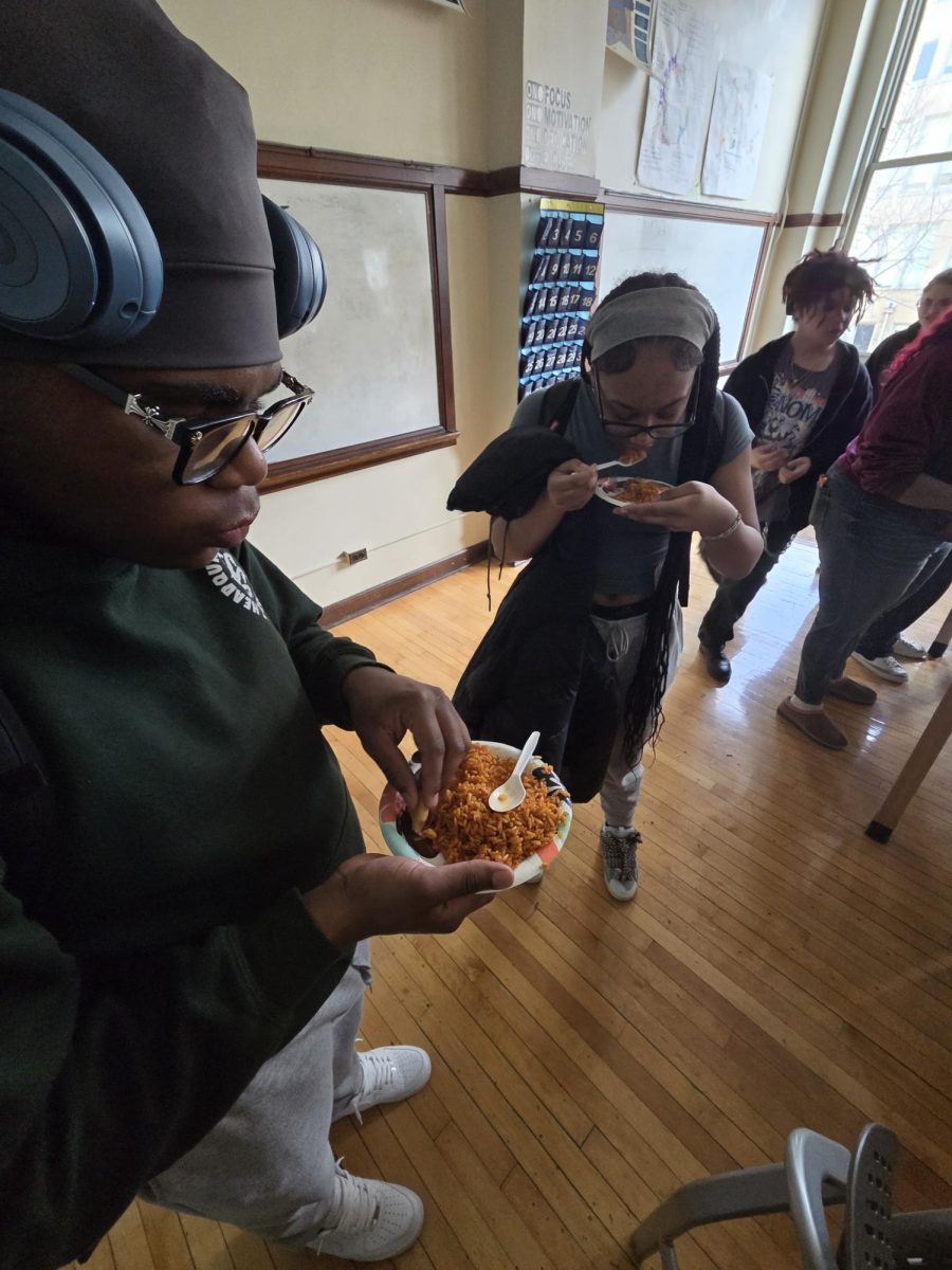 Students trying and eating the jollof rice served by the West African Club.