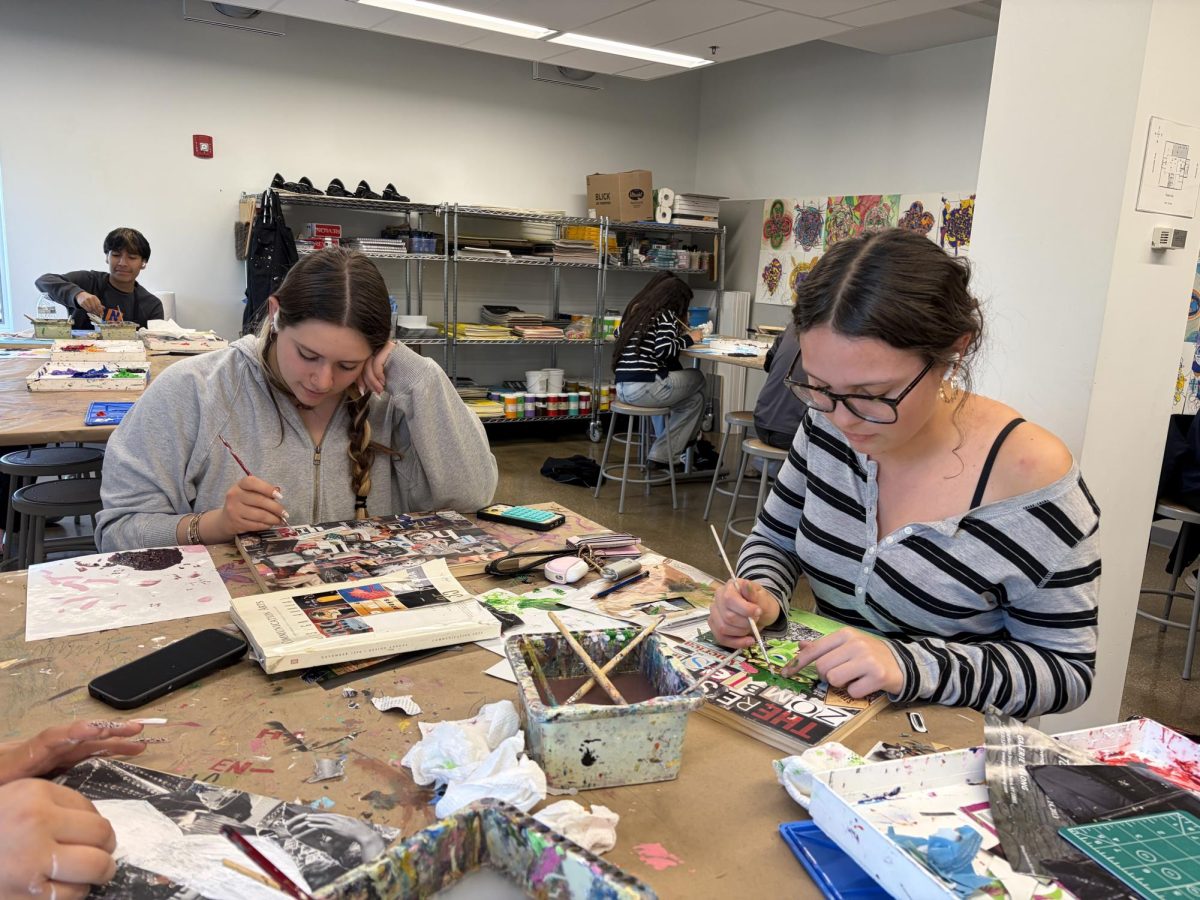 Sophomores Faye Marquiis and Thora Cox work collages in their Painting and Drawing program at the Lutz center located at 3435 N Cicero Ave.
