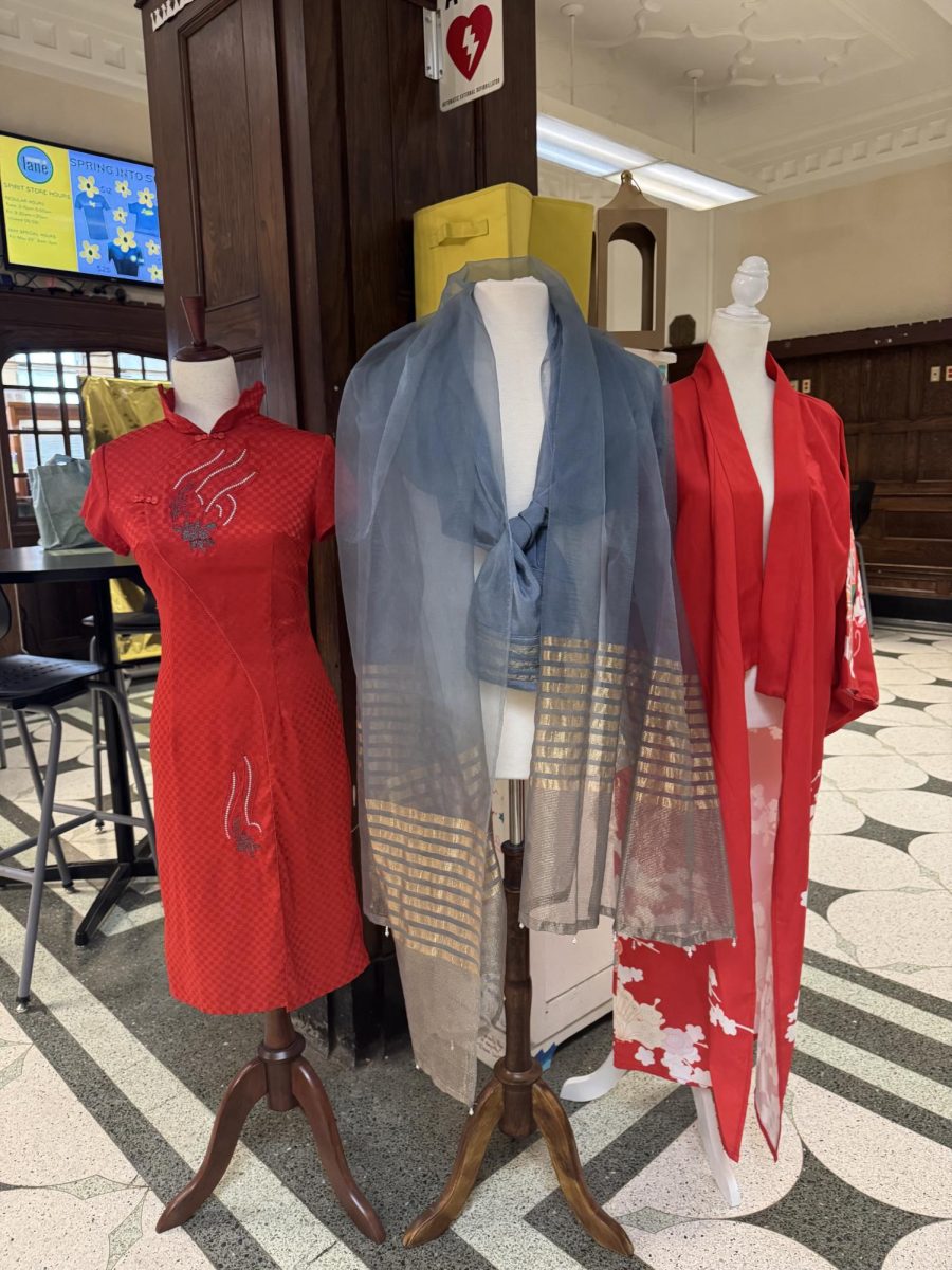 Traditional Asian clothes displayed on mannequins in the main office hallway.