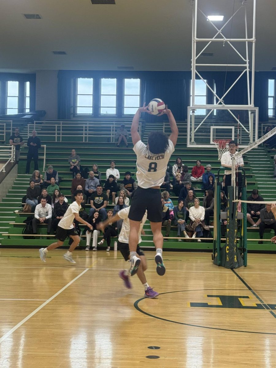 Senior Martin Nguyen sets up the ball to teammates during the first set of the game.
